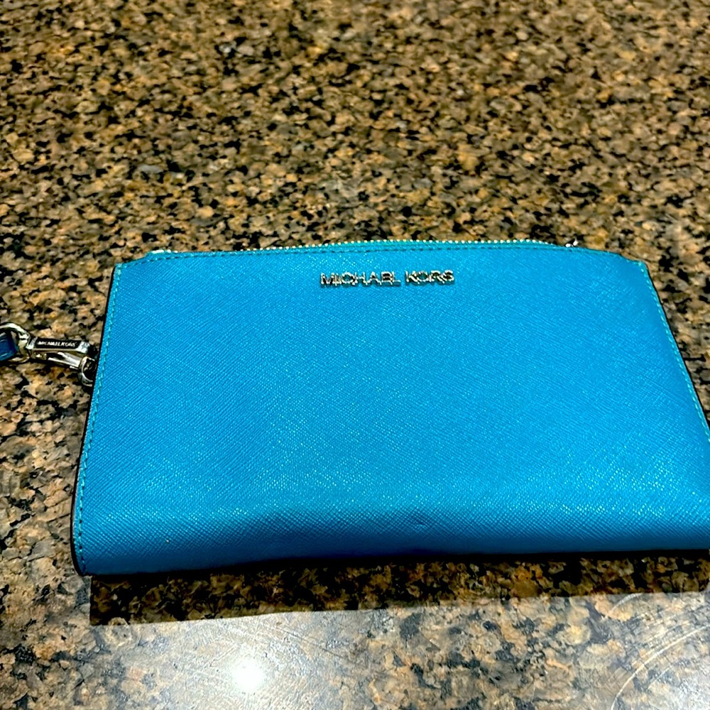 Cute wristlet.  Used one time. Like new. Turquoise with a silver zipper.